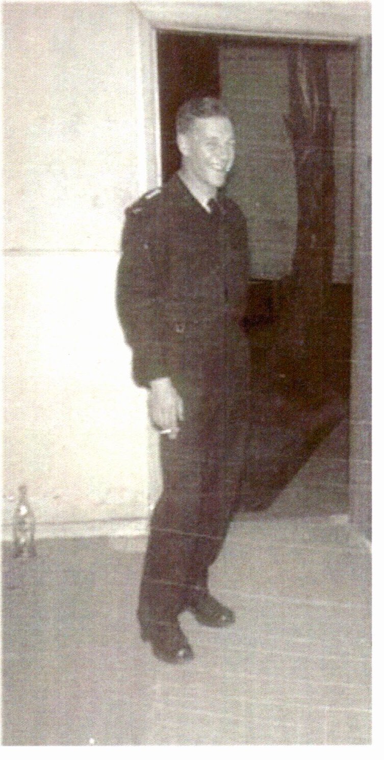 Derek Distel in Royal Australian Air Force uniform, standing in a doorway